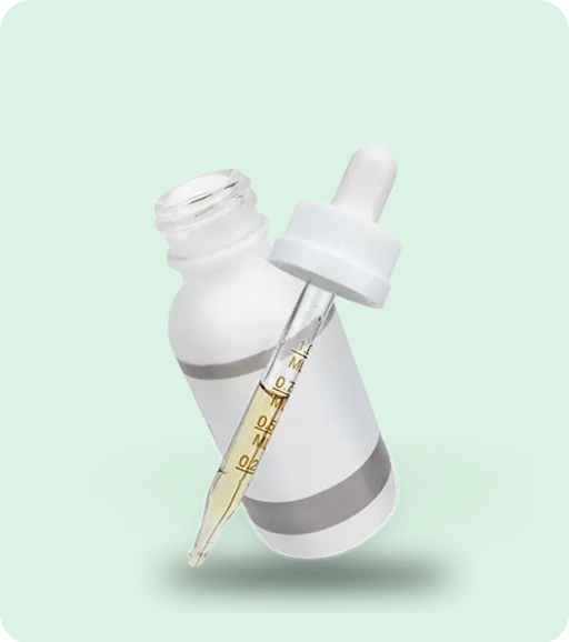 White dropper bottle and glass dropper filled with golden cannabis tincture oil displayed on a soft mint-green background, representing marijuana tincture products.
